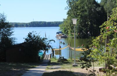 KiEZ Hölzerner See: Blick vom Ufer auf den See mit Steg und Booten